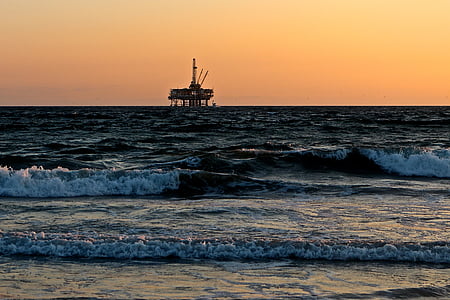 oil rig on the sea photo during sunset