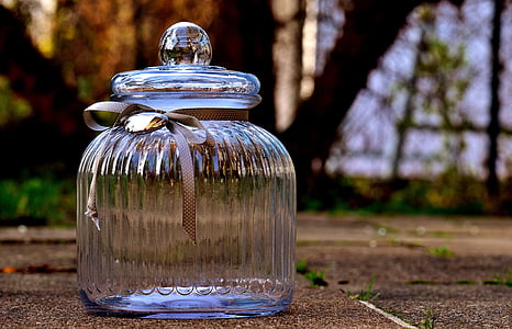 closeup photography of clear glass candy dish with lid