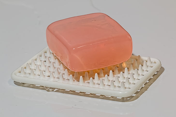 photo of pink bar soap on white soap dish
