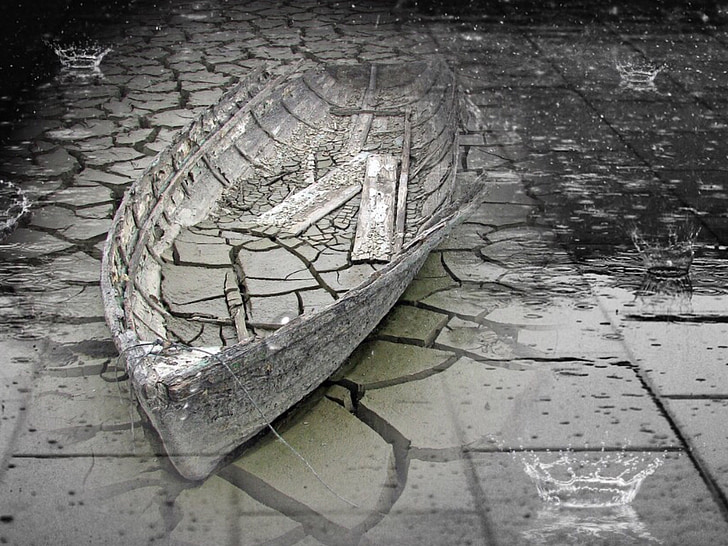 gray clinker boat on concrete pavement