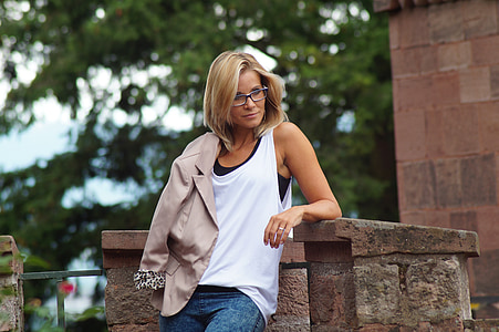 woman wearing white tank top and blue denim bottoms