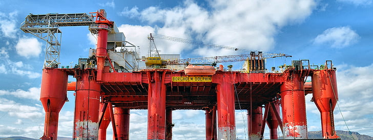 architectural photography of red oil rig