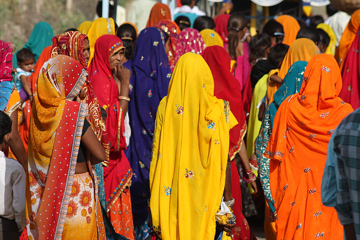 women wearing assorted-color sari while walking during daytime