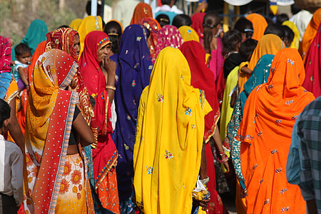 women wearing assorted-color sari while walking during daytime