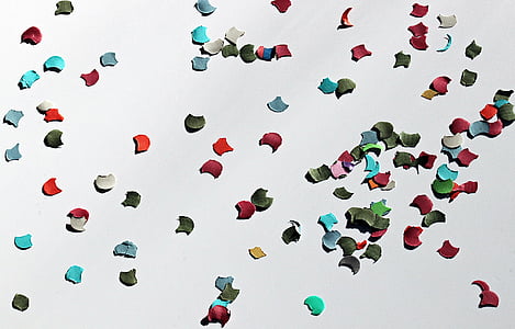 assorted-color one hole punch paper scattered on floor