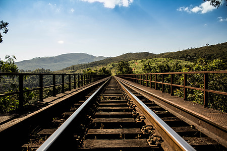 brown and grey train rails under grey sky