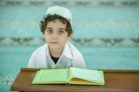 boy wearing white taqiyah