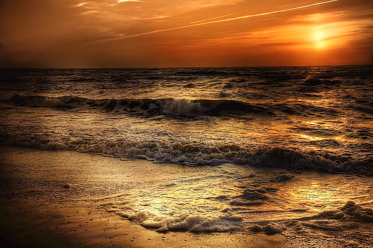 beach and sea waves during sunset
