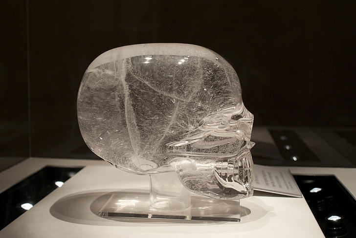 clear glass skull figurine on table