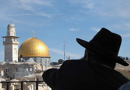man wearing black hat near temple during day