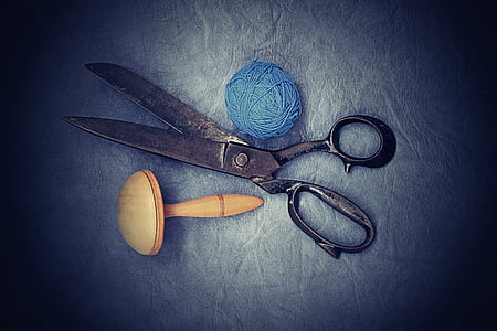 gray scissors near blue yarn