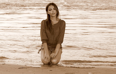 woman kneeling on seashore