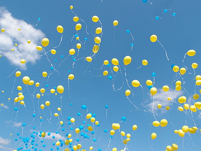 yellow balloons on the sky during daytime