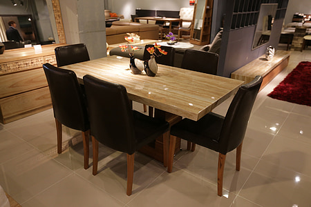 brown wooden table and six black parson chairs dining set