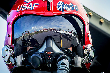 closeup of USAF fighter jet plane pilot on red helmet