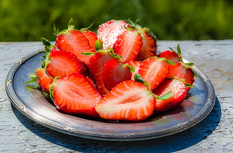 sliced strawberries on round gray plate
