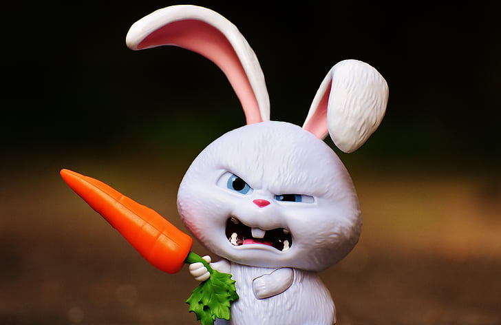 angry rabbit holding carrot figurine