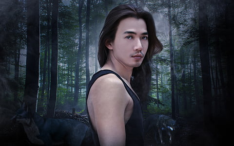 man wearing black tank top with forest background