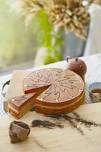 round caramel cake on brown chopping board