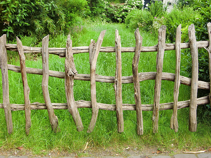 brown wooden fence near green grass