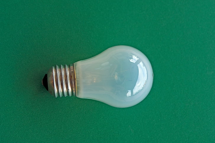 clear halogen bulb light on green surface