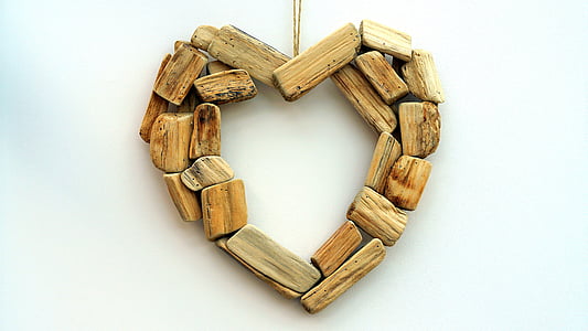 brown wooden heart cutout pendant with white background