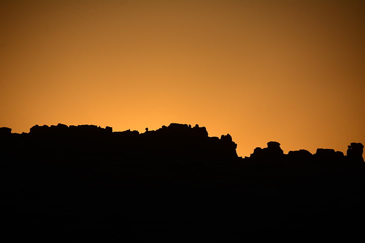 silhouette photography of rock formation during golden hour