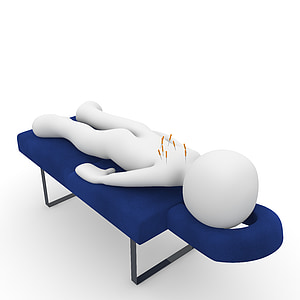 human figure lying on blue massage bed