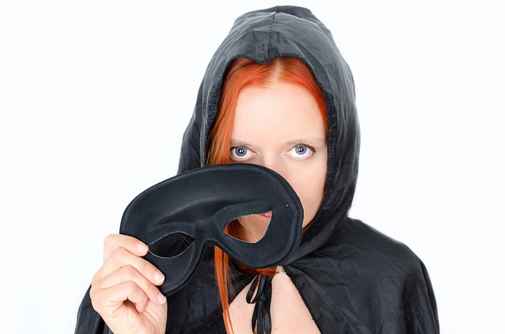 woman with red hair wearing black cowl