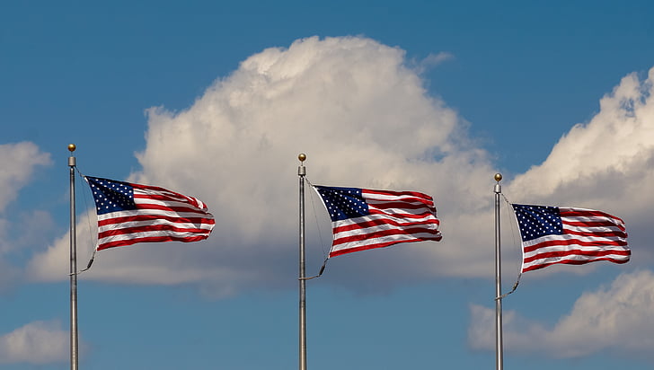 three US flag on poles