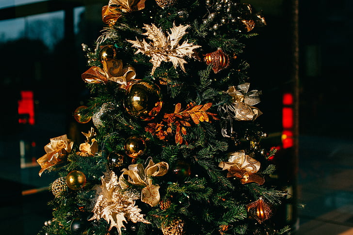 green Christmas tree with gold flower decors