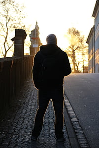 person standing on sidewalk