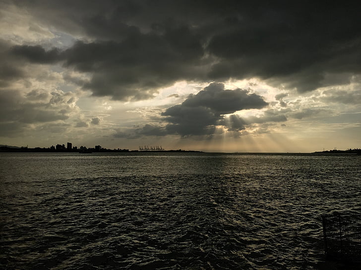 photo of island silhouette with clouds overhead