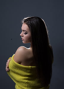 black haired woman with yellow off-shoulder top