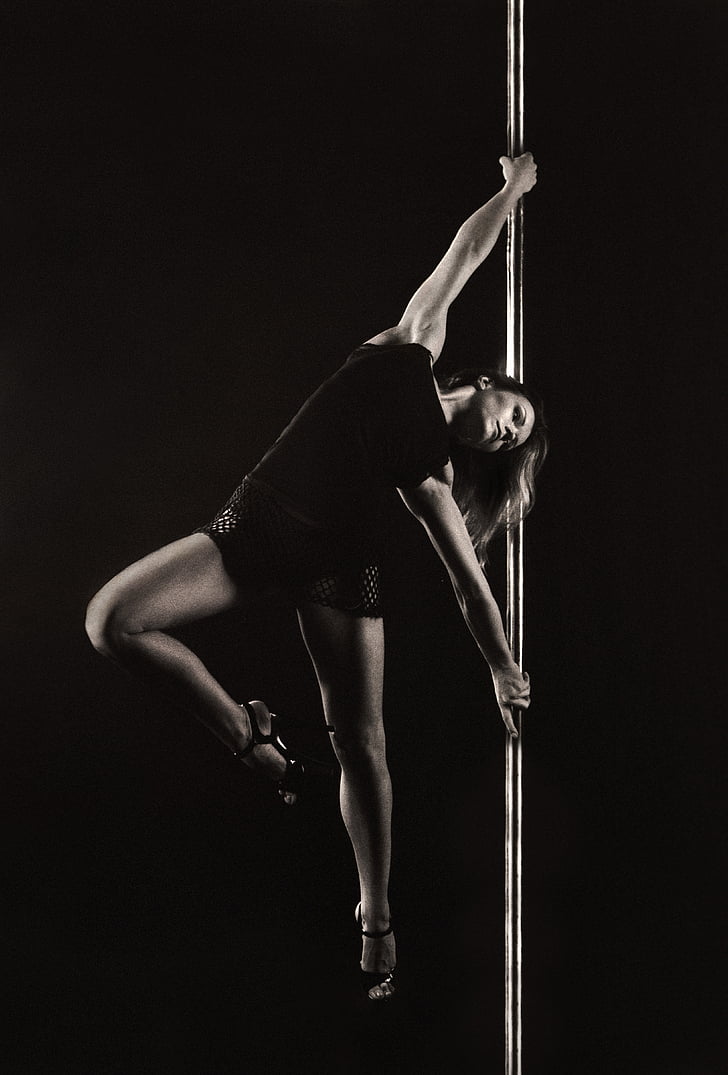 woman pole dancing during night time