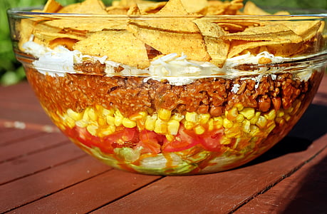 clear glass bowl with assorted snacks