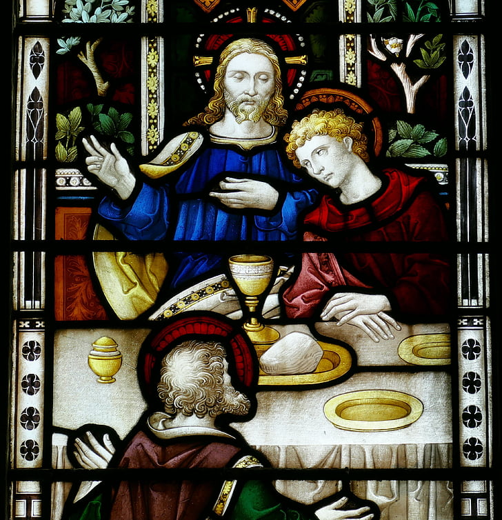 Jesus Christ beside saint stained glass window