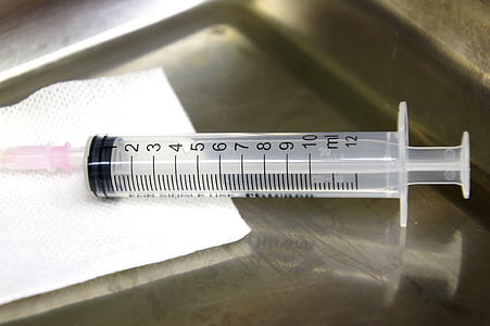 syringe near white tape