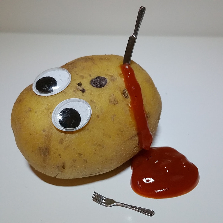 photography of knife on potato