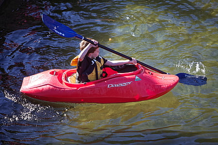 boy paddling using red boat