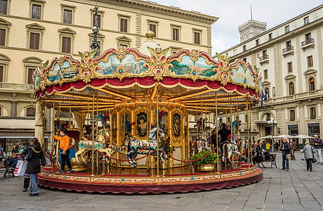 people riding horse carrousel