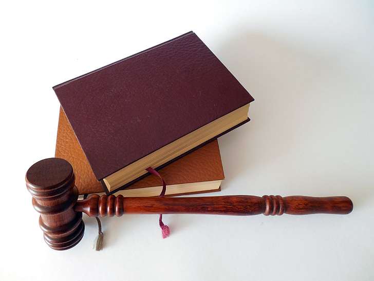 brown wooden gavel and two brown books