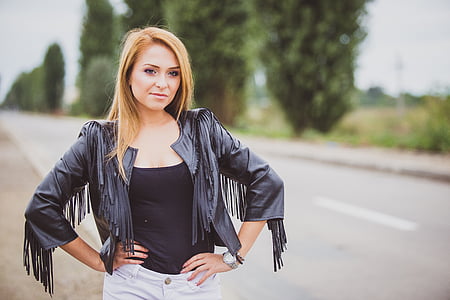 long blonde-haired woman in black leather jacket