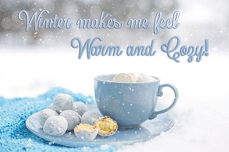 blue ceramic cup with bread balls on saucer with snow flakes background