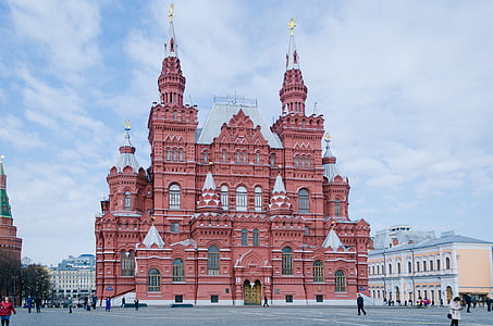 red castle surrounded by buildings