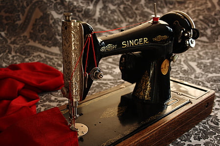 black and gray Single sewing machine with red textile