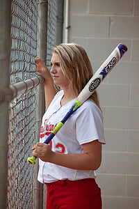 woman in white St. Louis Cardinals jersey shirt holding baseball bat
