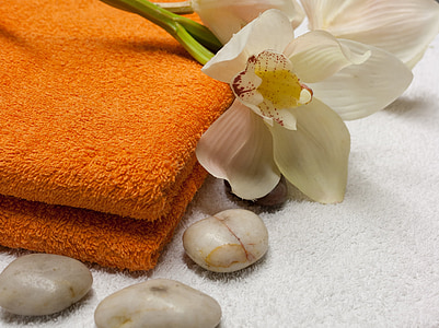 white orchids on orange fleece towel