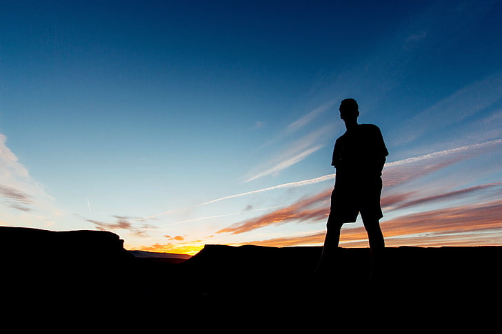 silhouette of person on hill