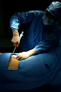 surgeon performing surgery on patient's body